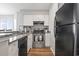 This kitchen includes granite countertops, stainless steel oven and plenty of storage with white cabinets and black refrigerator at 1100 Possum Trot Rd. # F218, North Myrtle Beach, SC 29582