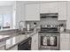 Well-lit kitchen featuring granite countertops, stainless steel oven, modern fixtures and white cabinets for a clean aesthetic at 1100 Possum Trot Rd. # F218, North Myrtle Beach, SC 29582