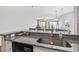 Bright kitchen with granite countertops, stainless steel oven, modern fixtures and a view of the dining and living areas at 1100 Possum Trot Rd. # F218, North Myrtle Beach, SC 29582