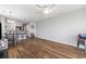 Open living room features wood flooring, a ceiling fan, and leads into the kitchen at 1100 Possum Trot Rd. # F218, North Myrtle Beach, SC 29582