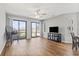 Bright living room has wood floors, a ceiling fan and sliding glass doors to outdoor patio at 1100 Possum Trot Rd. # F218, North Myrtle Beach, SC 29582