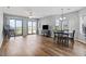 Open-concept living area with sliding glass doors to a deck, adjacent to a dining area with seating for six at 1100 Possum Trot Rd. # F218, North Myrtle Beach, SC 29582