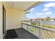 Outdoor patio with white wood railings and view of other neighborhood buildings and clear blue skies at 1100 Possum Trot Rd. # F218, North Myrtle Beach, SC 29582