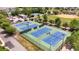 Aerial view of four tennis courts in the community surrounded by trees and parking lots at 1100 Possum Trot Rd. # F218, North Myrtle Beach, SC 29582