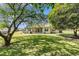 Backyard view showcasing a pool and grill area, sunroom, grassy yard, and mature trees at 1134 Carleita Circle, Conway, SC 29527