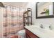 Bathroom featuring a patterned shower curtain, open shelves, and framed mirror at 1134 Carleita Circle, Conway, SC 29527