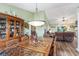 Intricate, carved dining room set adjacent to a living area with comfortable, brown leather seating at 1134 Carleita Circle, Conway, SC 29527