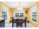 Bright dining area with sunny yellow walls and matching wooden table set for four at 1134 Carleita Circle, Conway, SC 29527