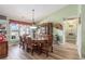 Dining room with carved wood table, cabinet, hardwood floors, and natural lighting at 1134 Carleita Circle, Conway, SC 29527