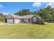 A well-maintained single story home with a garage, large front lawn, and mature landscaping at 1134 Carleita Circle, Conway, SC 29527