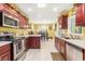 Eat-in kitchen with stainless steel appliances, ample counter space, and a view into the dining area at 1134 Carleita Circle, Conway, SC 29527
