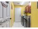 Well-lit laundry room features modern washer/dryer and cabinets for storage at 1134 Carleita Circle, Conway, SC 29527