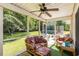 Enclosed sunroom featuring patio furniture and views of backyard, the pool, and the trees at 1134 Carleita Circle, Conway, SC 29527