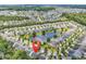 An aerial view of a home in a beautifully landscaped community with a pond at 1314 Prescott Circle, Myrtle Beach, SC 29577