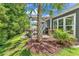 Backyard patio featuring lush landscaping, a palm tree, outdoor seating, grilling area, and a covered dining space at 1314 Prescott Circle, Myrtle Beach, SC 29577