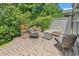 Private patio showcasing outdoor seating, a fire pit, mature landscaping, and a brick-paved ground at 1314 Prescott Circle, Myrtle Beach, SC 29577