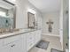 Spacious bathroom features double sink vanity, framed mirrors, tile floors, and glass shower with neutral tones at 1314 Prescott Circle, Myrtle Beach, SC 29577