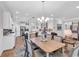 Bright dining area adjoining kitchen features hardwood floors, large windows, and modern lighting at 1314 Prescott Circle, Myrtle Beach, SC 29577