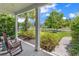 Inviting front porch view showcasing rocking chairs, lush landscaping, and a glimpse of the neighborhood at 1314 Prescott Circle, Myrtle Beach, SC 29577