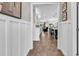 Inviting hallway with wainscoting and hardwood floors leading to an open kitchen and living area at 1314 Prescott Circle, Myrtle Beach, SC 29577