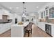 Bright kitchen featuring an island with seating, stainless steel appliances, and white cabinetry at 1314 Prescott Circle, Myrtle Beach, SC 29577