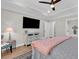 Bright main bedroom featuring tray ceiling, neutral tones, and doorway leading to en-suite bath and laundry at 1314 Prescott Circle, Myrtle Beach, SC 29577