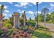 Community entrance sign with lush landscaping and palm trees at 1314 Prescott Circle, Myrtle Beach, SC 29577