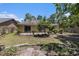 Well-maintained backyard featuring a cozy patio, lush greenery, and mature trees at 137 Hickory Dr., Conway, SC 29526
