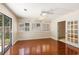 Bedroom with hardwood floors, ceiling fan, natural light, and backyard access at 137 Hickory Dr., Conway, SC 29526