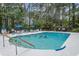 Community pool with several residents swimming and lounge chairs on the pool deck at 137 Hickory Dr., Conway, SC 29526