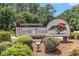 Myrtle Trace, a 55+ covenant restricted retirement community, shown on a large wooden sign at the entrance at 137 Hickory Dr., Conway, SC 29526