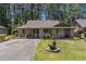 Charming single-story home featuring a well-manicured lawn and inviting curb appeal nestled amongst the trees at 137 Hickory Dr., Conway, SC 29526