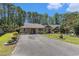 Charming single-story home featuring a well-manicured lawn and inviting curb appeal nestled amongst the trees at 137 Hickory Dr., Conway, SC 29526