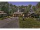 Charming single-story home featuring a well-manicured lawn and inviting curb appeal nestled amongst the trees at 137 Hickory Dr., Conway, SC 29526
