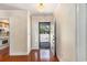 Bright foyer with hardwood floors and chandelier, offering a glimpse into the adjacent kitchen at 137 Hickory Dr., Conway, SC 29526