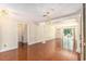 Open-plan living room with hardwood floors, decorative chandeliers, and views into the backyard at 137 Hickory Dr., Conway, SC 29526