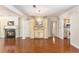 Spacious open-plan living room with hardwood floors, fireplace, and decorative chandelier at 137 Hickory Dr., Conway, SC 29526