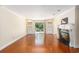 Large living room with hardwood floors, built-in shelving, fireplace, and sliding doors to the yard at 137 Hickory Dr., Conway, SC 29526