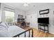Bedroom with a desk, a bed, and a wooden floor, offering a comfortable and functional space at 138 Copper Leaf Dr., Myrtle Beach, SC 29588