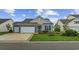 Inviting single-story home showcasing a well-kept lawn, brick accents, and an attached garage at 138 Copper Leaf Dr., Myrtle Beach, SC 29588