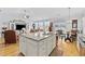 Open kitchen with granite counters, island, stainless sink, and light wood floors at 138 Copper Leaf Dr., Myrtle Beach, SC 29588