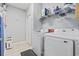 Functional laundry room with modern washer and dryer and overhead storage at 138 Copper Leaf Dr., Myrtle Beach, SC 29588