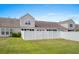 View of a home's backyard with a green lawn and white fence at 156 Parmelee Dr. # D, Murrells Inlet, SC 29576