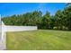 Large grassy backyard with a white vinyl fence and plenty of space for outdoor activities at 156 Parmelee Dr. # D, Murrells Inlet, SC 29576
