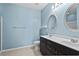 Bright bathroom features a double sink vanity with dark cabinets and decorative oval mirrors at 156 Parmelee Dr. # D, Murrells Inlet, SC 29576