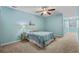 Inviting bedroom with soft blue walls, neutral carpet, a ceiling fan, and a comfortable bed at 156 Parmelee Dr. # D, Murrells Inlet, SC 29576