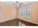 Bedroom with beautiful dark hardwood floors, a ceiling fan, and plantation shutters at 156 Parmelee Dr. # D, Murrells Inlet, SC 29576