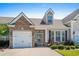 Charming single-Gathering home featuring a stone facade, attached garage, and well-manicured front yard at 156 Parmelee Dr. # D, Murrells Inlet, SC 29576