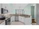 Modern kitchen featuring granite countertops, stainless steel appliances, and ample cabinet space for storage at 156 Parmelee Dr. # D, Murrells Inlet, SC 29576