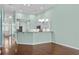 Stylish kitchen with granite counters, white cabinets, a breakfast bar and stainless steel sink at 156 Parmelee Dr. # D, Murrells Inlet, SC 29576